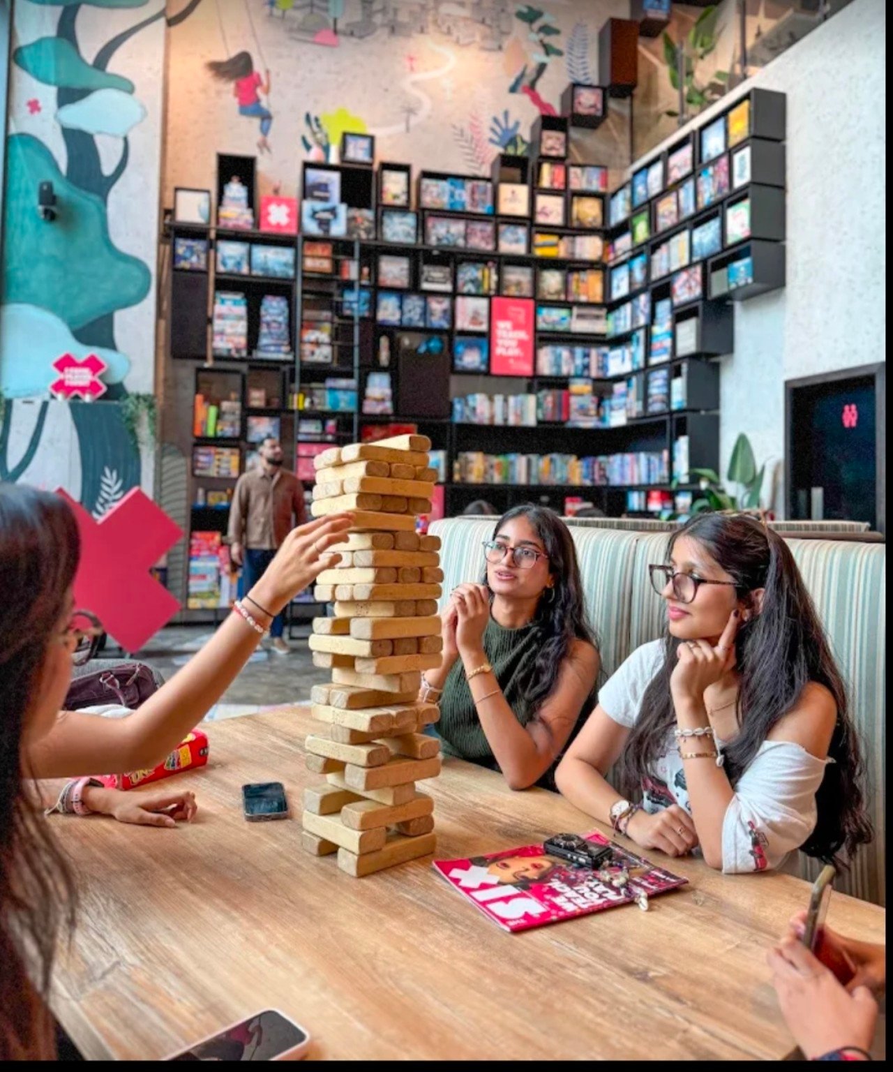 Friends playing giant Jenga at The Six